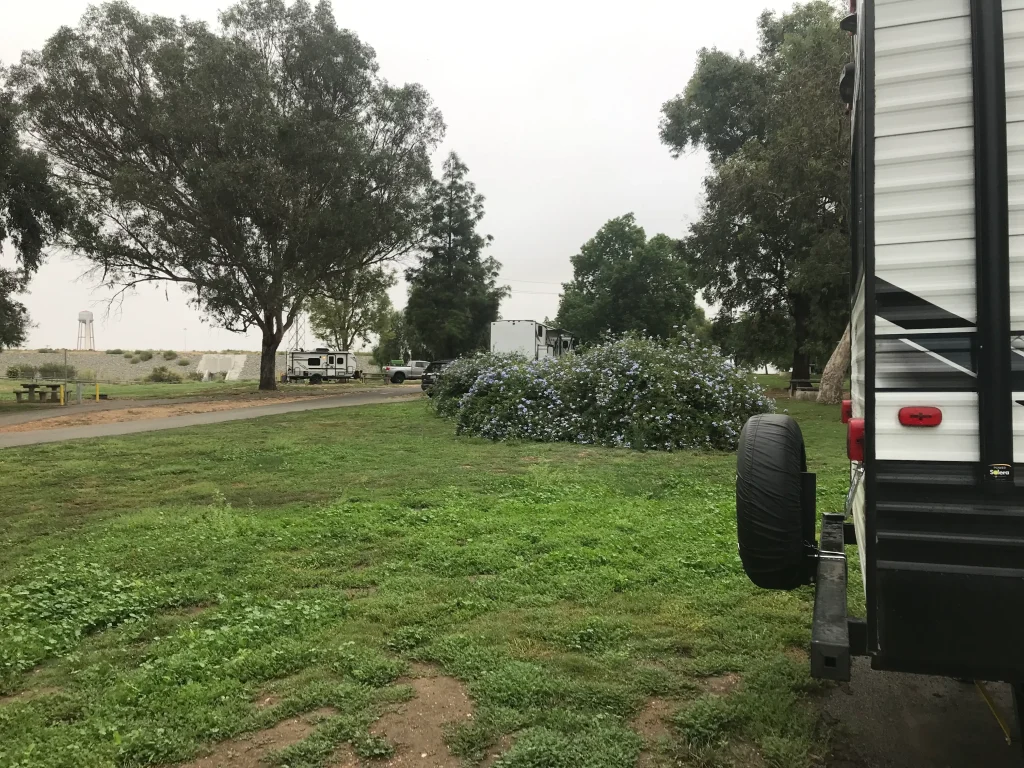 Shaded RV site surrounded by green trees at Canyon RV Park in Orange County