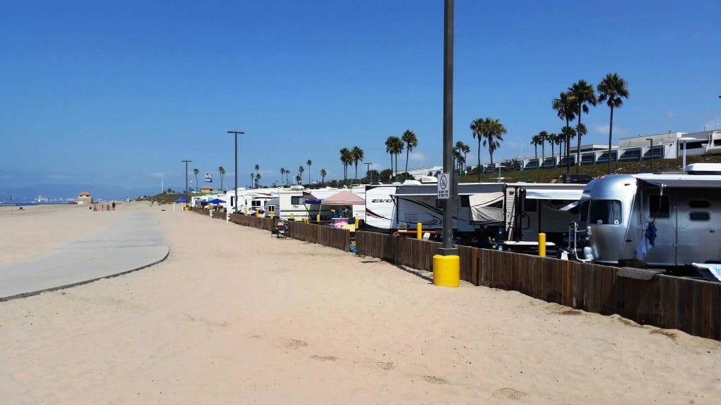 Beachfront RV sites at Dockweiler RV Park with palm trees and Pacific Ocean views